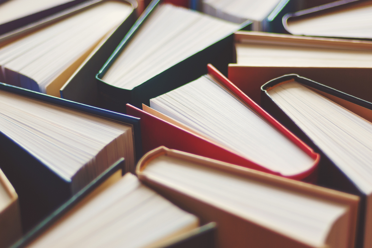 Many hardbound books background, selective focus